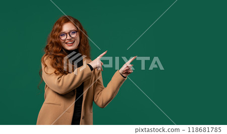 Recommending smiling BusinessWoman pointing at side copy space or advertising. 118681785