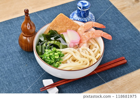 Cold udon noodles, cold udon noodles in soup, shrimp, fried tofu, kamaboko, seaweed, and green onions. 118681975