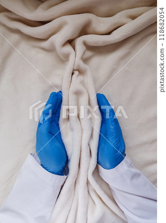 The hands of a gynecologist support the folds of soft tissue in the shape of the labia, vagina and vulva. The concept of women's intimate health, prevention of gynecological diseases 118682054