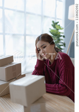 woman online seller, struggles to achieve her goals, facing challenges and experiencing no success in her ecommerce business woman online seller, struggles to achieve her goals, facing challenges and experiencing no success in her ecommerce business 118682092