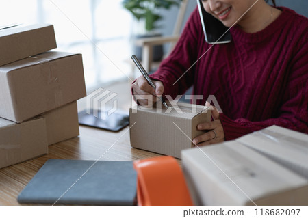 woman, online seller, using smartphone to calling customers, goals, and drive success in her e-commerce business 118682097