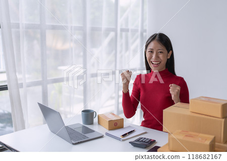 woman, online seller, Achieves sales success happiness using a tablet computer, goals, and drive success in her e-commerce business woman, online seller, Achieves sales success happiness using a tablet computer, goals, and drive success in her e-commerce business 118682167