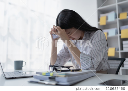 businesswoman plans a finance audit, reviewing documents while battling burnout syndrome. businesswoman plans a finance audit, reviewing documents while battling burnout syndrome. 118682468