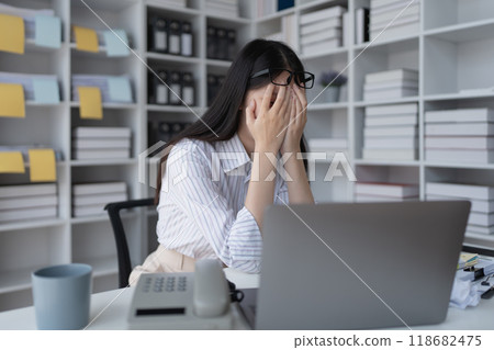 businesswoman plans a finance audit, reviewing documents while battling burnout syndrome. businesswoman plans a finance audit, reviewing documents while battling burnout syndrome. 118682475