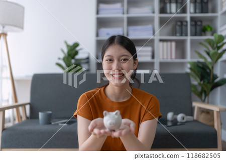 woman carefully develops a financial saving plan, organizing her resources to achieve long-term financial security and stability woman carefully develops a financial saving plan, organizing her resources to achieve long-term financial security and stability 118682505
