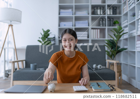 woman creates a detailed financial saving plan using a calculator to organize her expenses and ensure long-term financial stability and security woman creates a detailed financial saving plan using a calculator to organize her expenses and ensure long-term financial stability and security 118682511