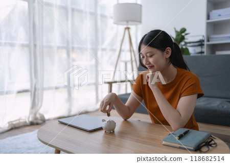 woman carefully develops a financial saving plan, organizing her resources to achieve long-term financial security and stability woman carefully develops a financial saving plan, organizing her resources to achieve long-term financial security and stability 118682514