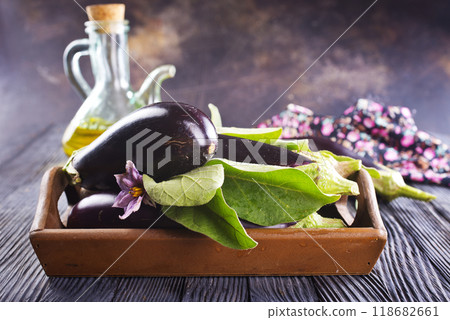 Raw eggplants ( aubergines ) in wooden box. Selective focus Raw eggplants ( aubergines ) in wooden box. Selective focus 118682661