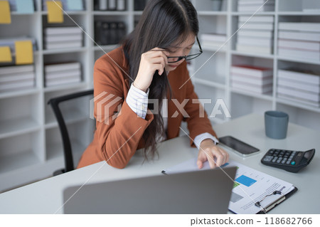 businesswoman plans a finance audit, reviewing documents while battling burnout syndrome. businesswoman plans a finance audit, reviewing documents while battling burnout syndrome. 118682766