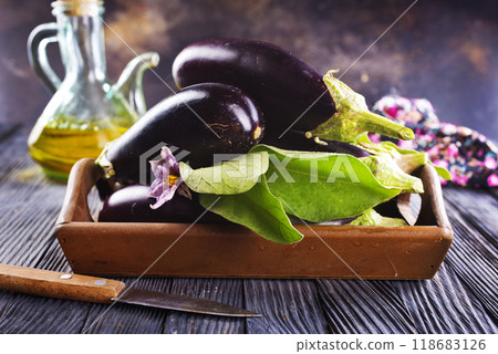 Raw eggplants ( aubergines ) in wooden box. Selective focus 118683126