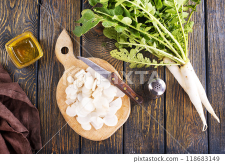 White radish and knife on wooden board 118683149