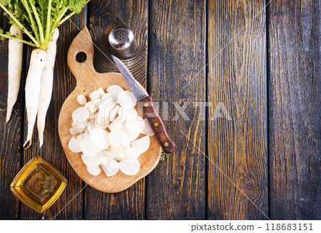 White radish and knife on wooden board 118683151