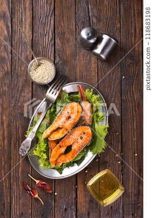 roast salmon steaks with fresh salad on plate roast salmon steaks with fresh salad on plate 118683198