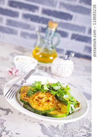 Heap of fried green zucchini with garlic Heap of fried green zucchini with garlic 118683216