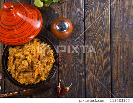 Uzbek cuisine food pilaf, rice with carrots, vegetable oil, raisins 118683503
