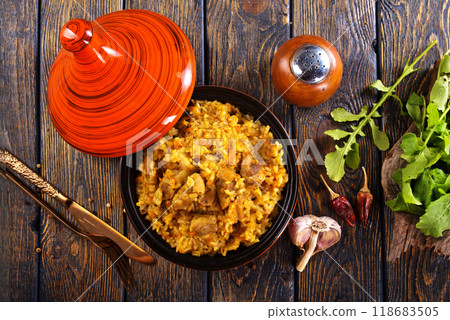 Uzbek cuisine food pilaf, rice with carrots, vegetable oil, raisins 118683505