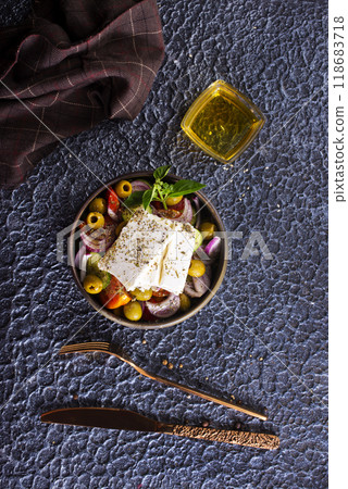 Greek salad of fresh juicy vegetables, feta cheese, herbs and olives Greek salad of fresh juicy vegetables, feta cheese, herbs and olives 118683718
