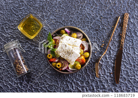 Greek salad of fresh juicy vegetables, feta cheese, herbs and olives Greek salad of fresh juicy vegetables, feta cheese, herbs and olives 118683719