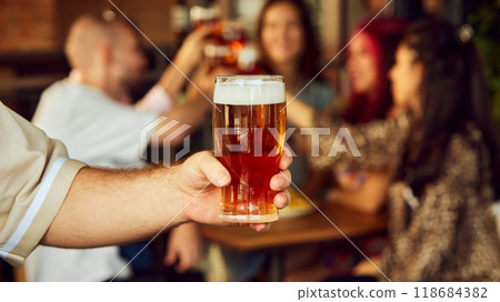 Together, they toast to every goal, every triumph, and every unforgettable moment that makes being sport fan so thrilling. Selective focus. Together, they toast to every goal, every triumph, and every unforgettable moment that makes being sport fan so thrilling. Selective focus. 118684382