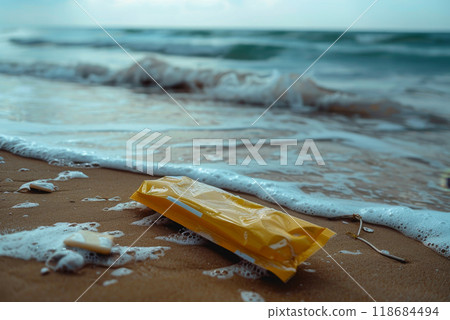 a plastic packaging, in the beach coast, pollution, garbage. 118684494
