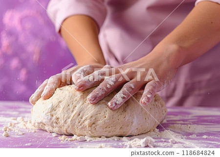A woman is kneading dough, isolated on a purple background. she testing the dough for baking bread. 118684824