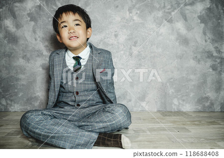 5-year-old child sitting in a suit 5-year-old child sitting in a suit 118688408