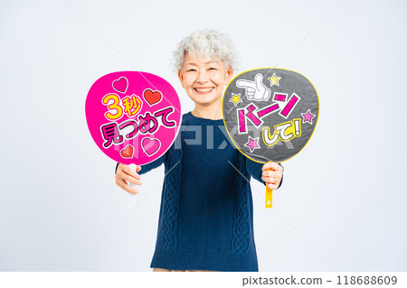 Senior woman holding a fan 118688609
