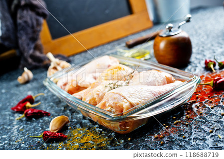 Raw chicken drumsticks with seasonings in glass plate. Chicken legs ready to cook. Raw chicken drumsticks with seasonings in glass plate. Chicken legs ready to cook. 118688719
