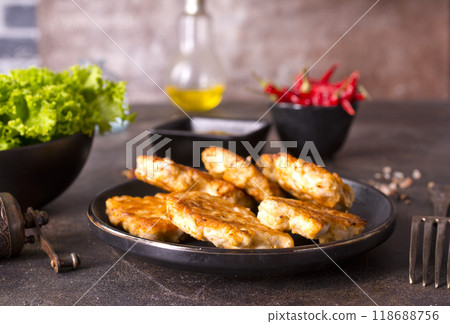 Roasted chicken cutlets on black plate Roasted chicken cutlets on black plate 118688756