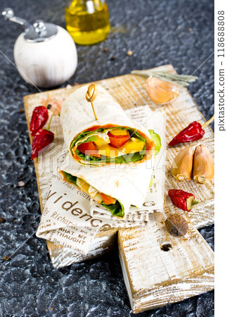 Shawarma sandwich with vegetable and cheese. Traditional Middle Eastern snack. On wooden background 118688808