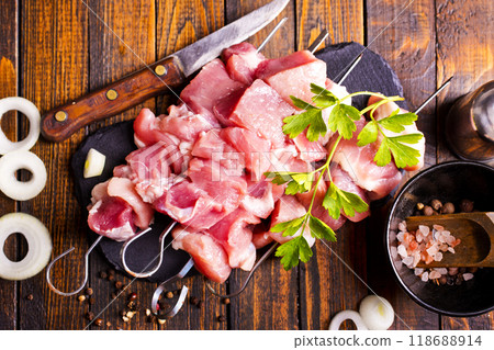 Raw meat shish kebab skewers. Wooden background. Raw meat shish kebab skewers. Wooden background. 118688914