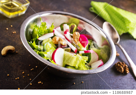 A salad of fresh organic radish, cucumber with dill and green onions dressed with oil 118688987