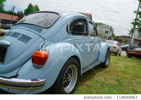 Close-up of the front of a beautiful blue car. Exhibition of retro cars from the 60s in the city street. 118689063