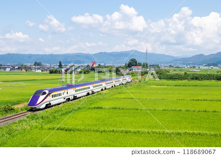 [Yamagata Line] A mini Shinkansen train running through a rural landscape 118689067