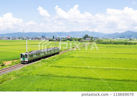 [Yamagata Line] A local train running through rural scenery 118689070