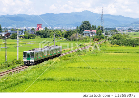 [Yamagata Line] A local train running through rural scenery 118689072