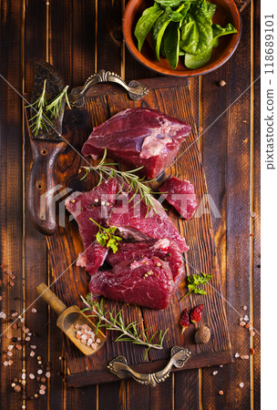 Raw meat with herbs and garlic, marble meat. Wooden background. Top view. 118689101