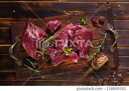 Raw meat with herbs and garlic, marble meat. Wooden background. Top view. 118689102