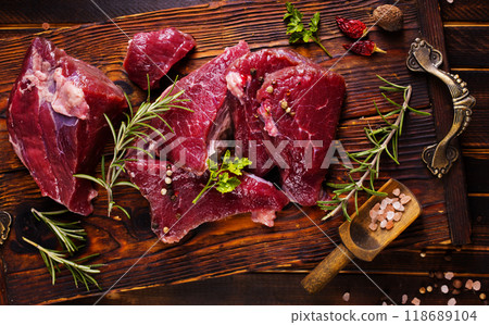 Raw meat with herbs and garlic, marble meat. Wooden background. Top view. 118689104