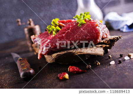 Raw meat with herbs and garlic, marble meat. Wooden background. Top view. 118689413