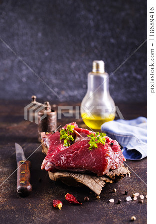 Raw meat with herbs and garlic, marble meat. Wooden background. Top view. 118689416