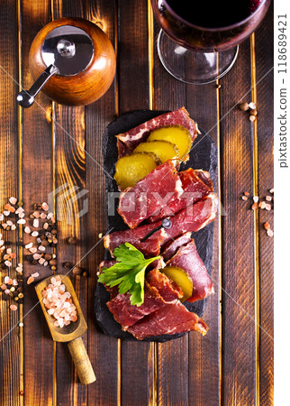 Flat slices of square sandwich ham with herbs. Dark background. Top view. Copy space. Flat slices of square sandwich ham with herbs. Dark background. Top view. Copy space. 118689421
