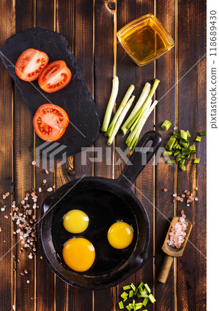 Raw chicken eggs on dark table 118689430