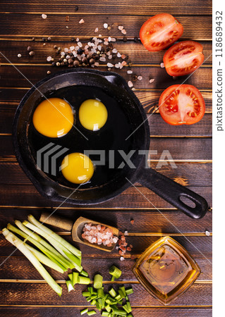 Raw chicken eggs on dark table 118689432