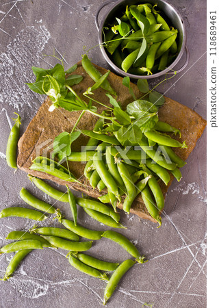 Pods of green peas with leaves. Fresh food background. Top view 118689461