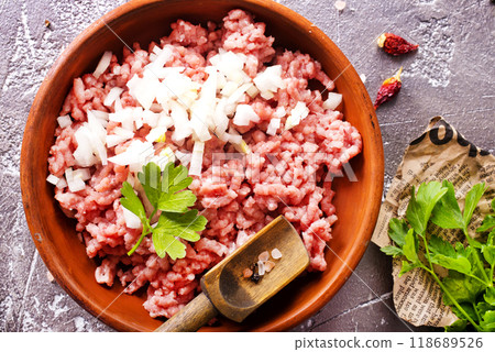 Homemade minced meat with ingredients for making in a bowl over dark slate, stone or concrete background. 118689526