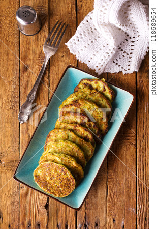 Zucchini Fritters with Herbs and Cream Cheese Topping, Tasty Vegetable Pancakes Zucchini Fritters with Herbs and Cream Cheese Topping, Tasty Vegetable Pancakes 118689654