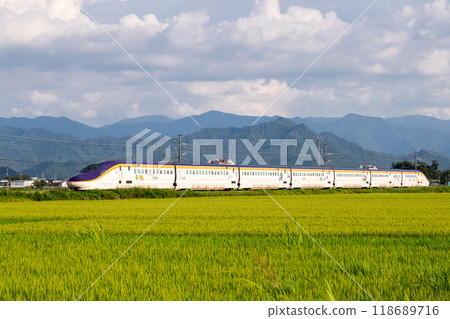 [Yamagata Line] A mini Shinkansen train running through a rural landscape 118689716