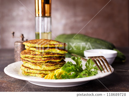 Zucchini Fritters with Herbs and Cream Cheese Topping, Tasty Vegetable Pancakes Zucchini Fritters with Herbs and Cream Cheese Topping, Tasty Vegetable Pancakes 118689728