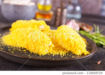chicken wings with panko in a gray ceramic bowl on a rustic table ready to cooking chicken wings with panko in a gray ceramic bowl on a rustic table ready to cooking 118689729